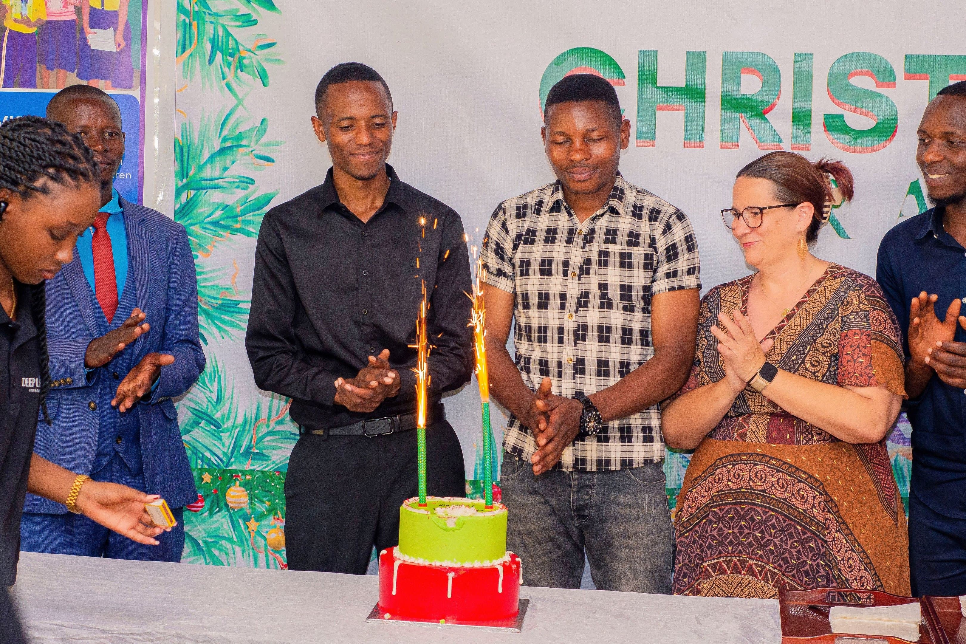 Deep Light Fountain team celebrating with a cake